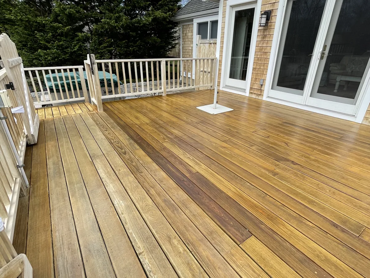 Deck cleaning beside exterior windows by ClearView on Martha's Vineyard